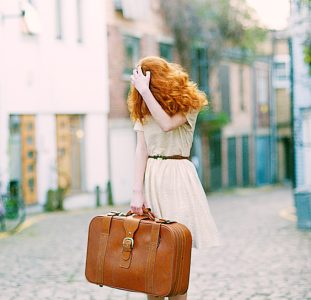 woman-in-white-short-sleeved-dress-holding-brown-leather-1071078